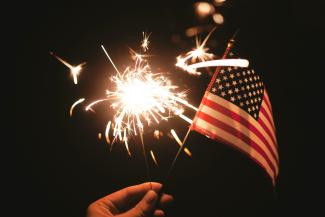 time lapse photography of sparkler and U.S.A flag let by Stephanie McCabe courtesy of Unsplash.