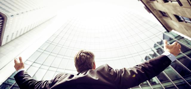low-angle photography of man in the middle of buidligns by Razvan Chisu courtesy of Unsplash.