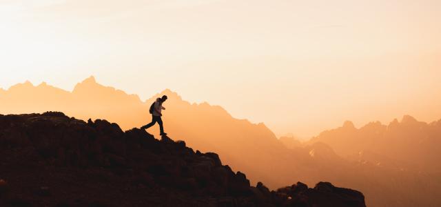 a person standing on top of a mountain by NEOM courtesy of Unsplash.
