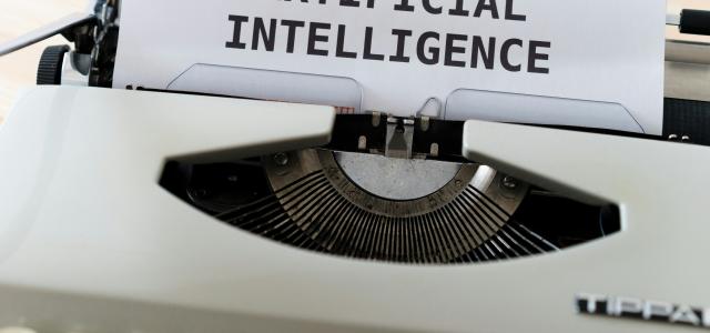 white and black typewriter with white printer paper by Markus Winkler courtesy of Unsplash.